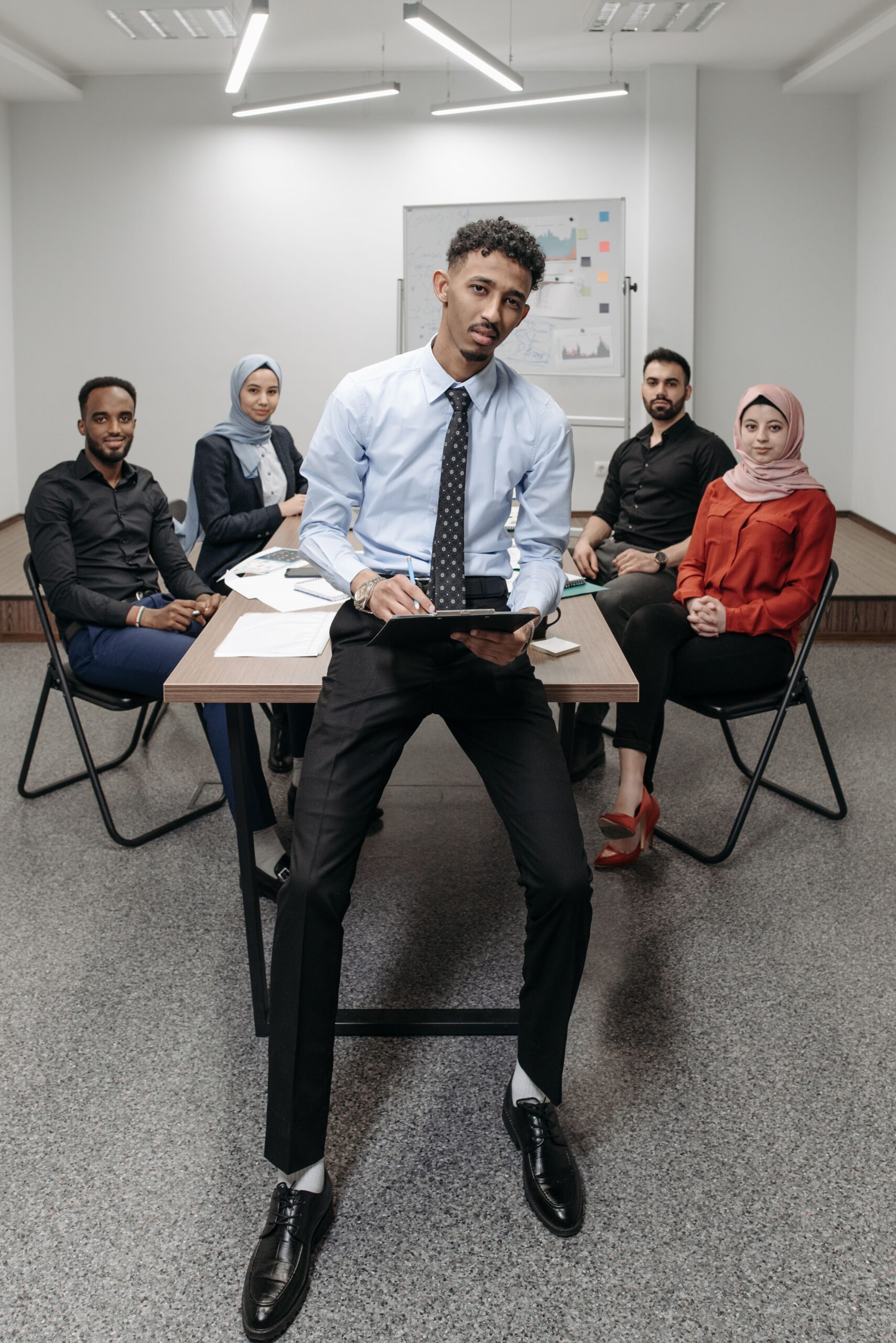 A diverse team discussing in an office meeting room, showcasing collaboration and teamwork.