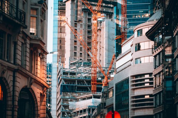 Dynamic city street scene with modern skyscrapers and construction in London, UK.