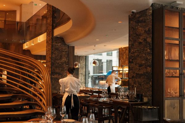 Stylish restaurant interior with patrons and staff in London, UK.